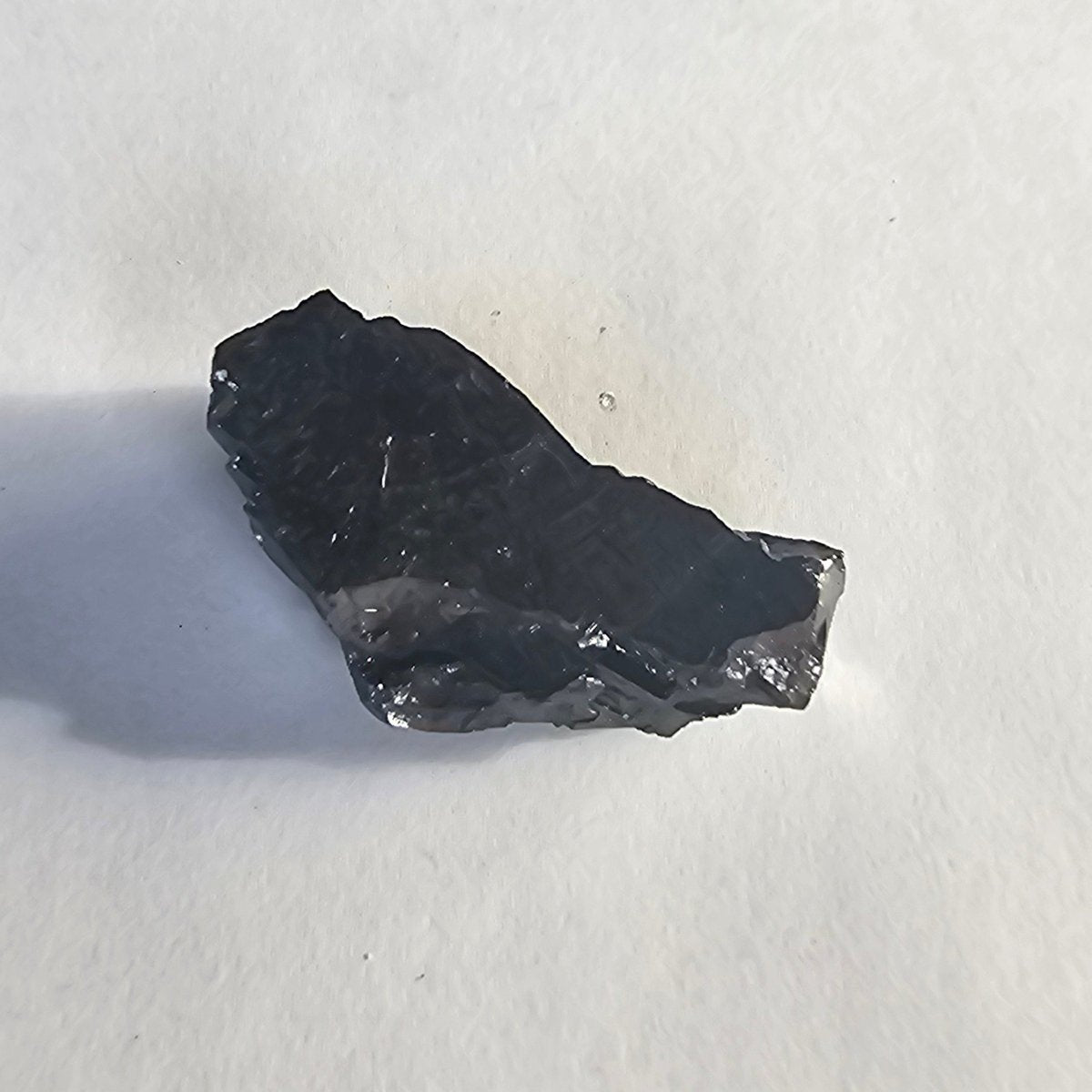 Ruapehu elite shungite nugget, 12g: flat slab-like piece with a sloping top, wider at one end