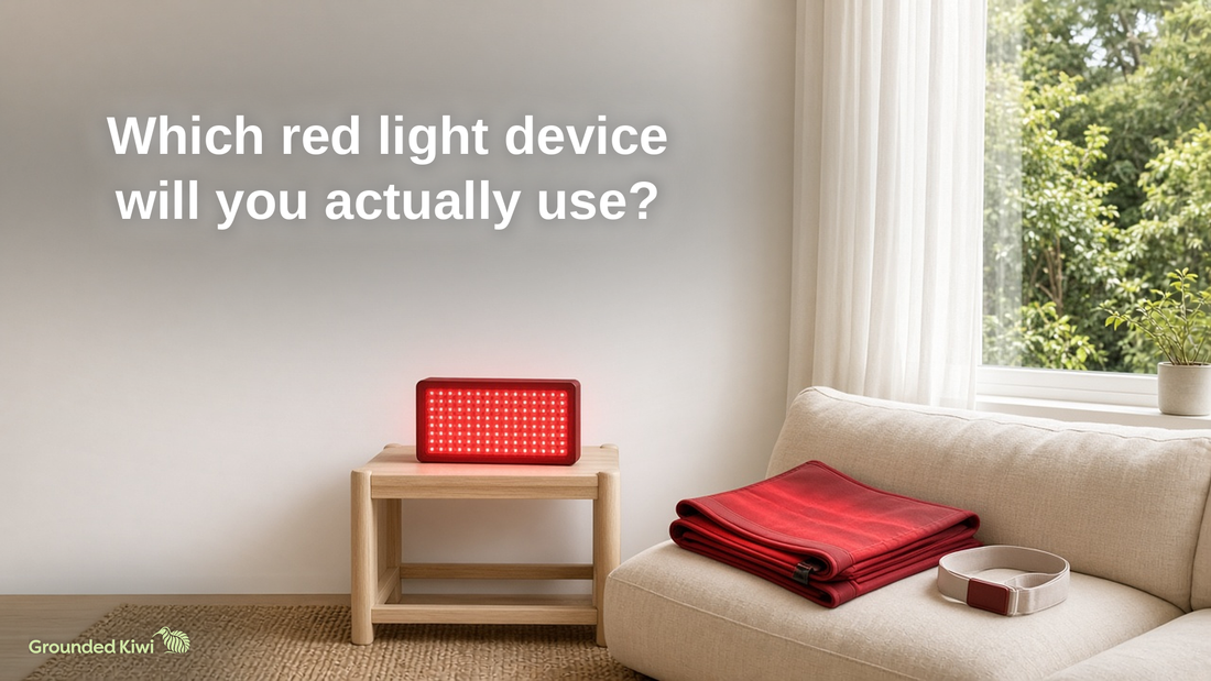 Compact red light panel glowing on a side table beside a couch with a folded red wrap, with the title ‘Which red light device will you actually use?’