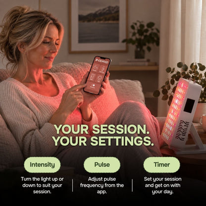Woman controlling tabletop red light therapy panel from a phone app with intensity pulse and timer settings