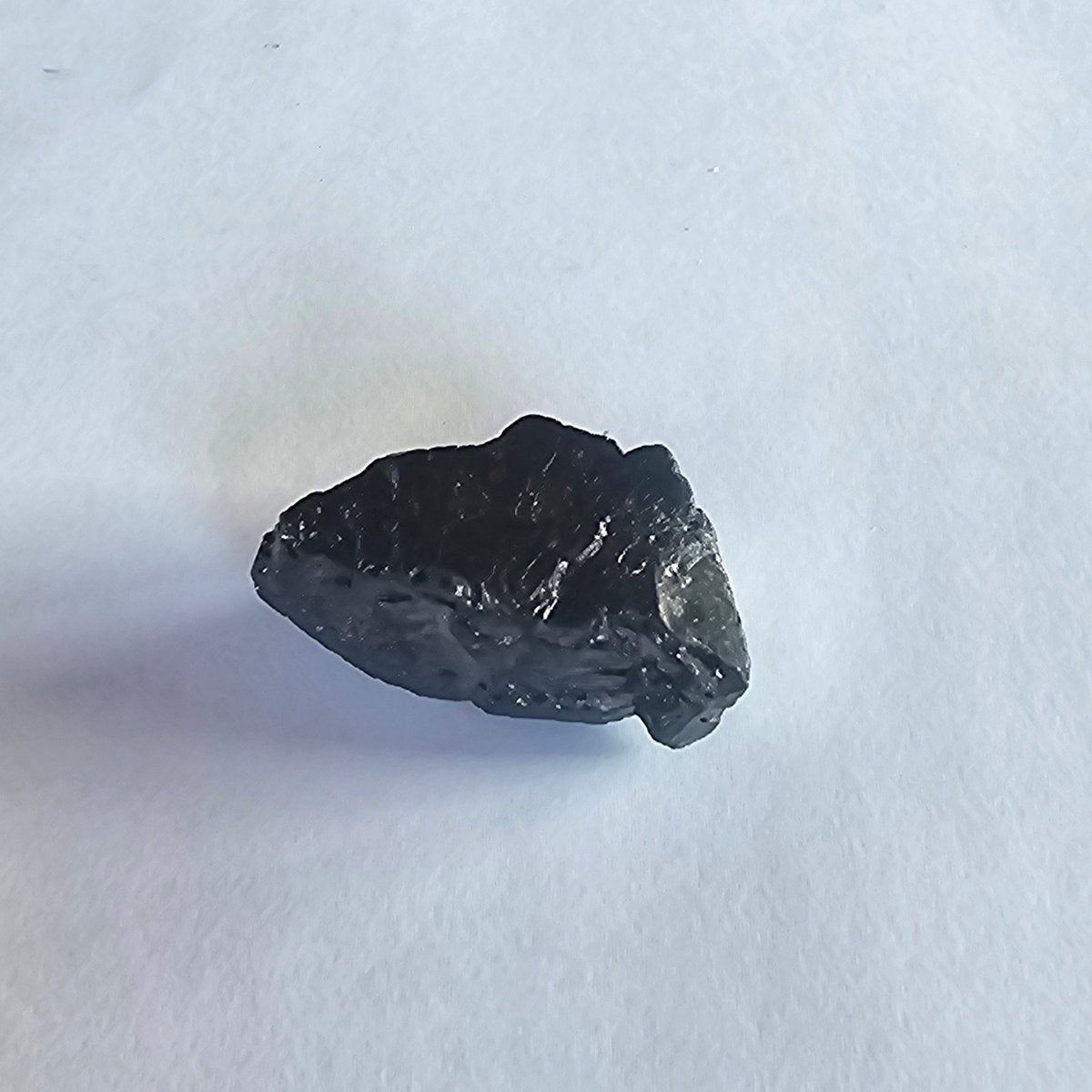 Mount Cook elite shungite nugget, 12.5g: small matte wedge shaped like an arrowhead pointing left