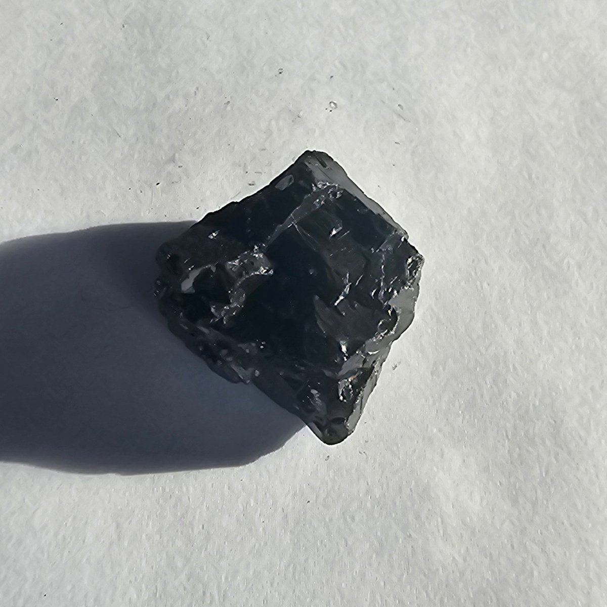 Aconcagua shungite crystal, 13.4g one-piece nugget: squarish nugget sitting diamond-wise with a sharp flat top edge